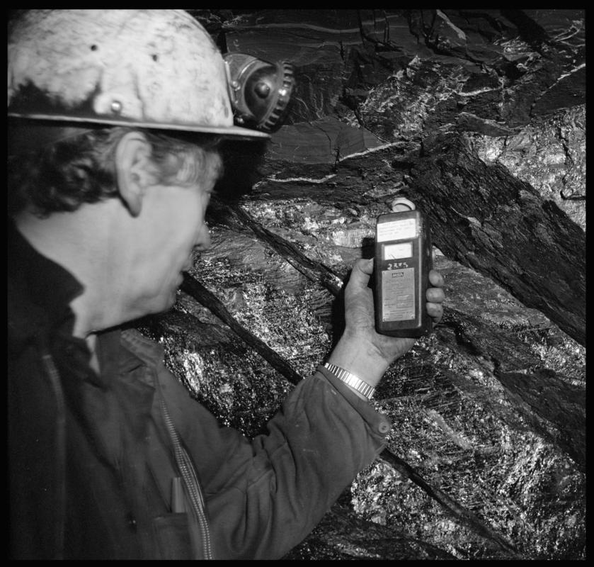 Black and white film negative showing a man holding a methanometer, Deep Duffryn Colliery.