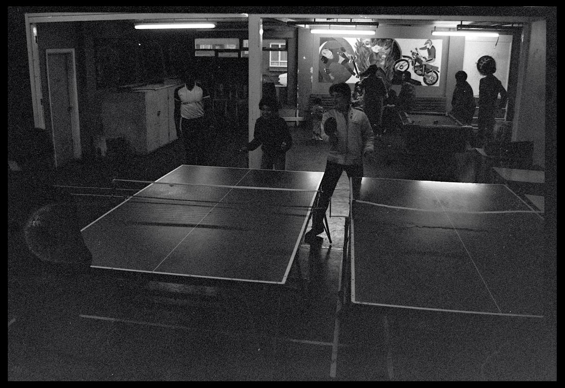 Teenagers playing table tennis at Butetown Youth Club.