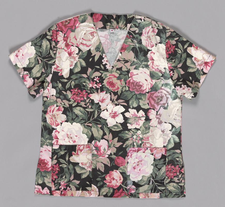 Floral shirt, part of a two piece scrubs set. Made from printed cotton furnishing fabric, machine sewn.