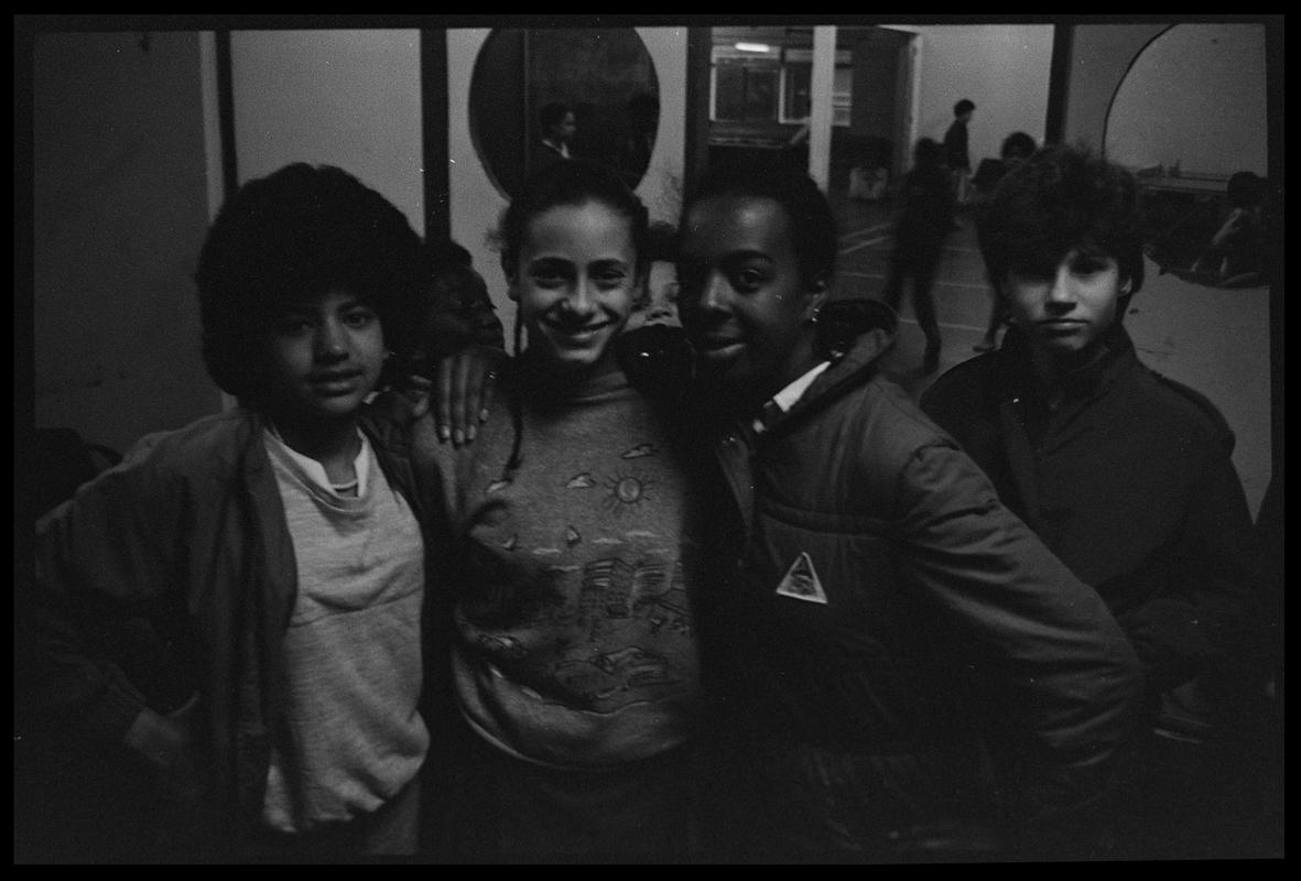 Teenagers standing by door in Butetown Youth Club.