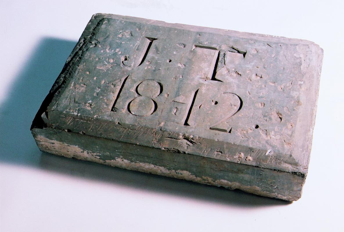 Stone plaque, "J.T 1842". Recovered from incline shaft at Gogine Lead Mines.