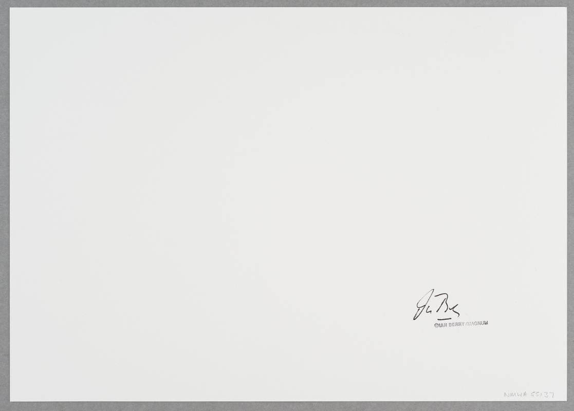 A young black girl, scarcely more than a child herself, looks after a baby girl for a white family, South Africa