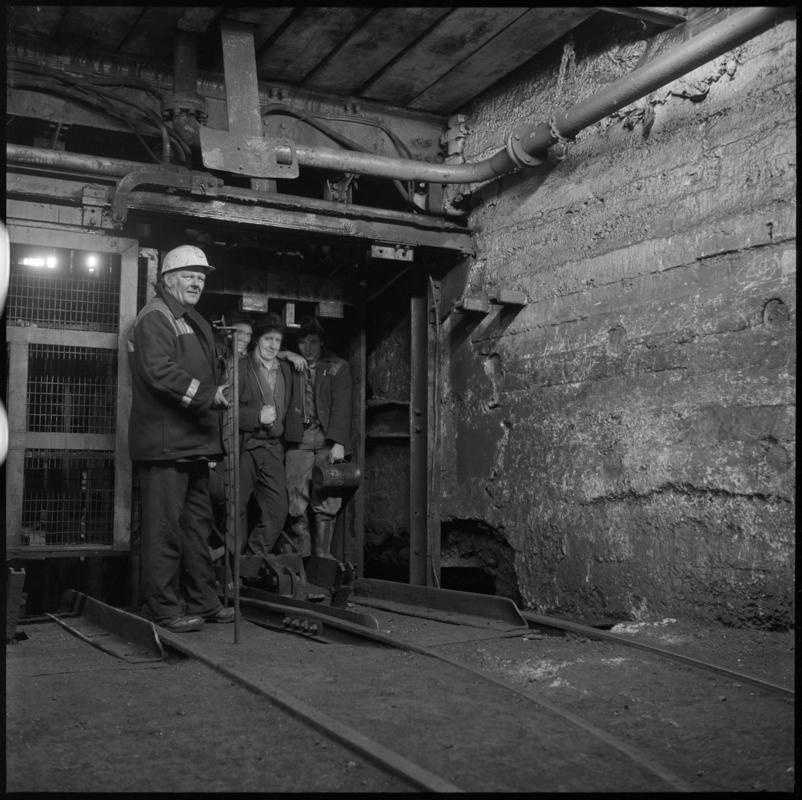 Black and white film negative showing miners in the cage at pit bottom, Wyndham Colliery. 'Wyndham' is transcribed from original negative bag.