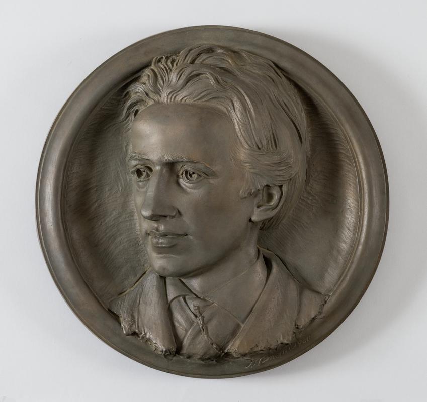 Circular bronze relief of Henry Latham.