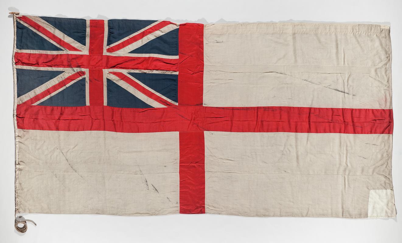 Ensign flag consists of the flag of St George (red cross on white ground) with the Union Jack flag fitted into the upper left quarter. Flown on the Terra Nova during Captain Robert Falcon Scott's exoedutuion to the South Pole, 1910 - 1913.