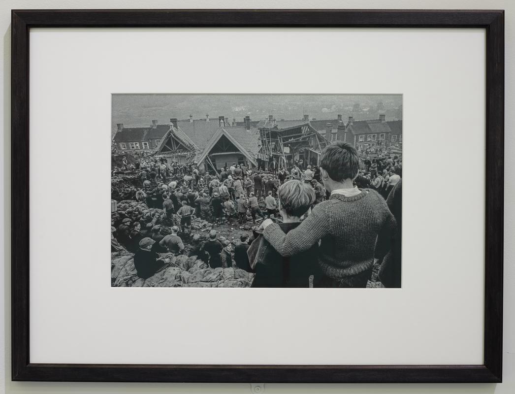 Aberfan Coal Slip Disaster. Two surviving children stand at the top of the hill overlooking the miners digging to find children still buried in the slag