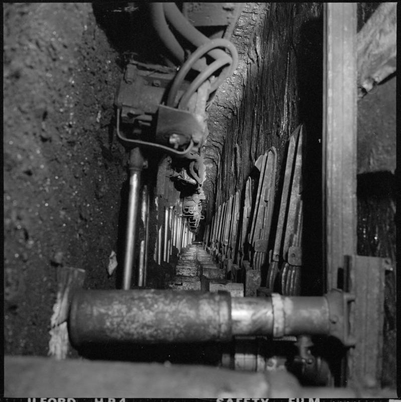 Black and white film negative showing a plough on the coalface? Cwmtillery Colliery 25 November 1977.  'Cwmtillery, 25 November 1977' is transcribed from original negative bag.
