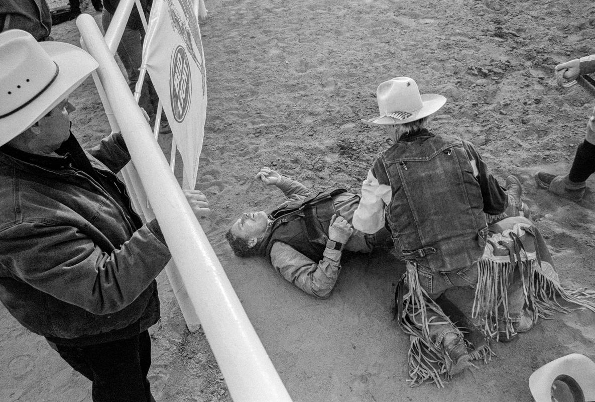 USA. ARIZONA. Buckeye Senior Rodeo, man tossed from bull. Only a broken rib. 2002