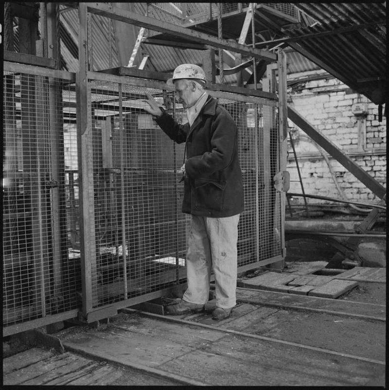Black and white film negative showing Glyn Morgan, NCB Manager at pit top, Big Pit Colliery
