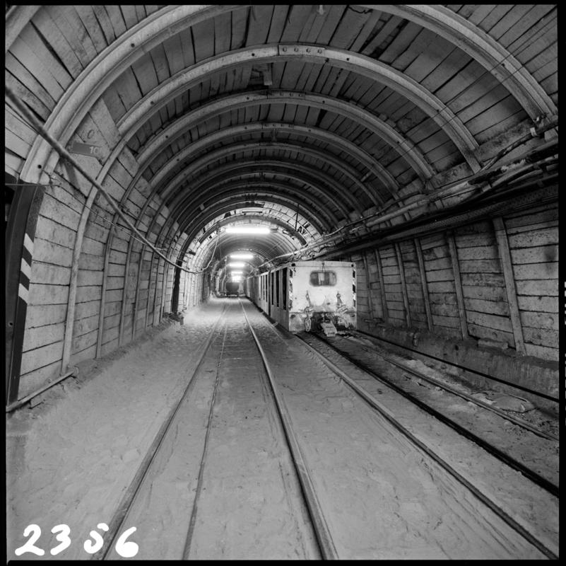 Black and white film negative showing an electric locomotive underground at Merthyr Vale Colliery, 2 July 1981.  '2 Jul 1981' is transcribed from original negative bag.  Appears to be identical to 2009.3/1853.