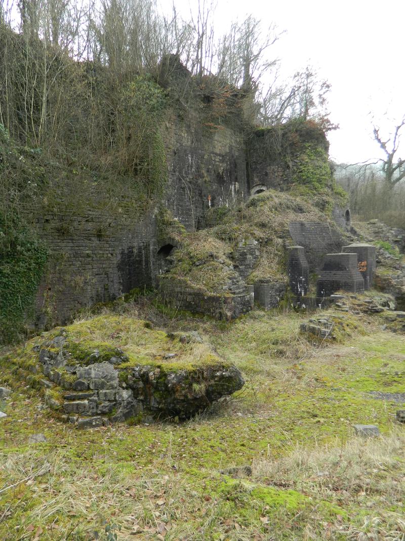 Clydach Ironworks: ëbearí of solidified slag marking site of no.3 blast furnace in foreground; partly reconstructed base of no.2 blast furnace in background, viewed from south east.