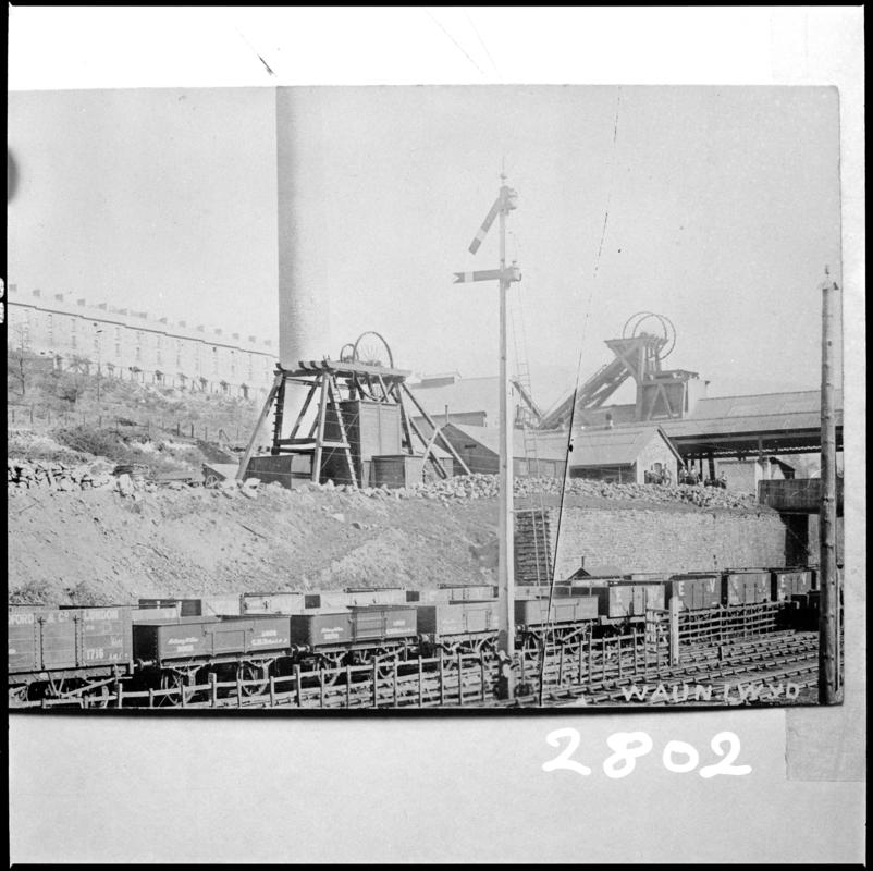 Black and white film negative of a photograph showing a surface view of Waunlwyd Colliery c.1900.  'Waunlwyd' is transcribed from original negative bag.