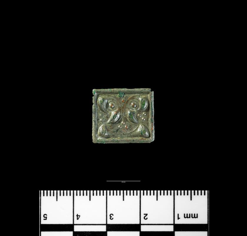 Roman copper alloy plaque with triskele decoration