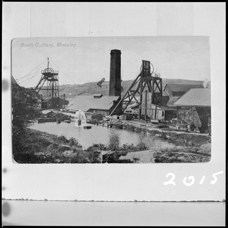 Black and white film negative of a postcard showing a general surface view of Garth Colliery, Maesteg. 'Garth Colliery' is transcribed from original negative bag.