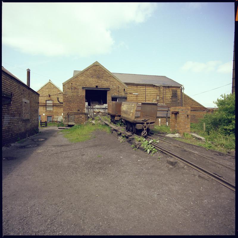 Colour film negative showing a haulage engine and drams, Morlais Colliery. 'Morlais' is transcribed from original negative bag.