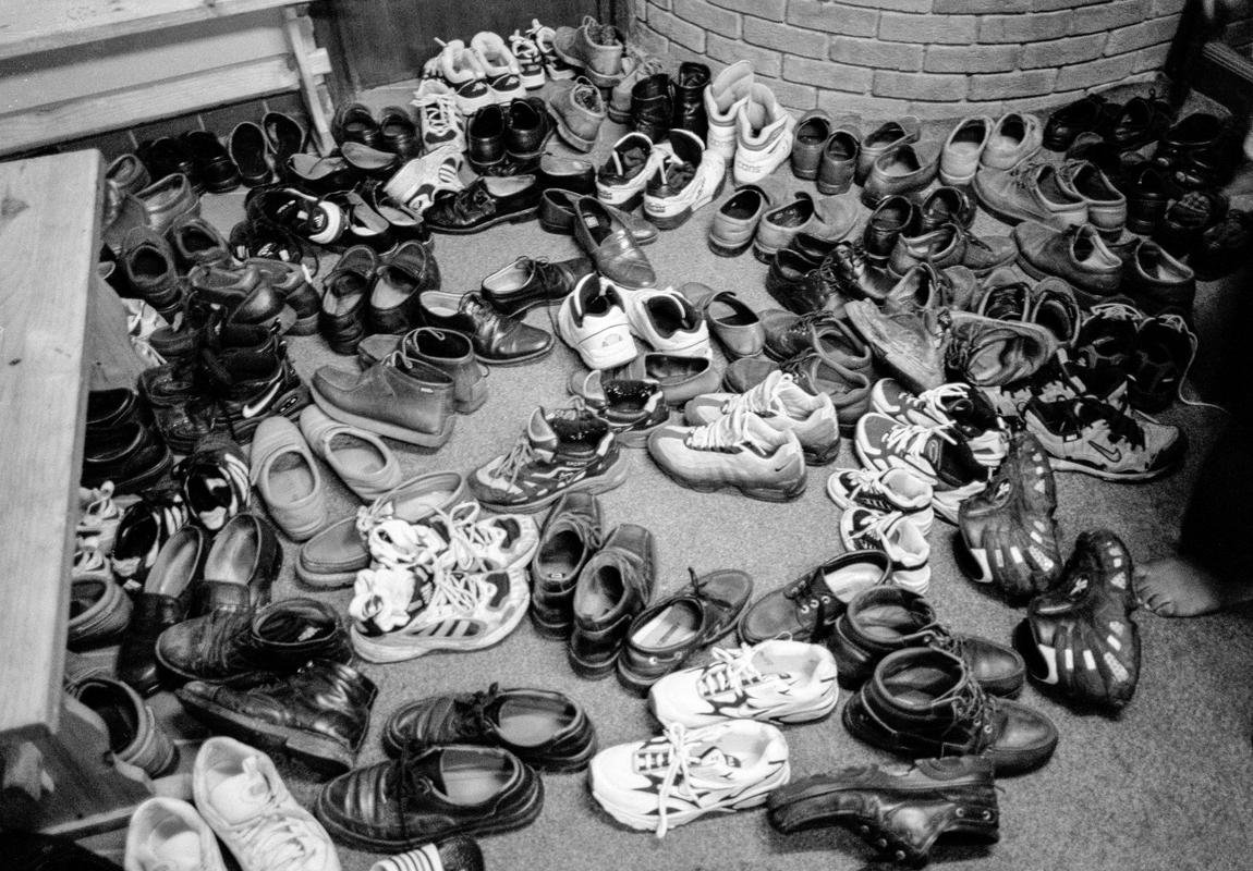 GB. WALES. Cardiff. Butetown- once know as 'Tiger Bay'. The shoes of the faithful, inside the Alice Street Mosque, Butetown, Cardiff. 1999