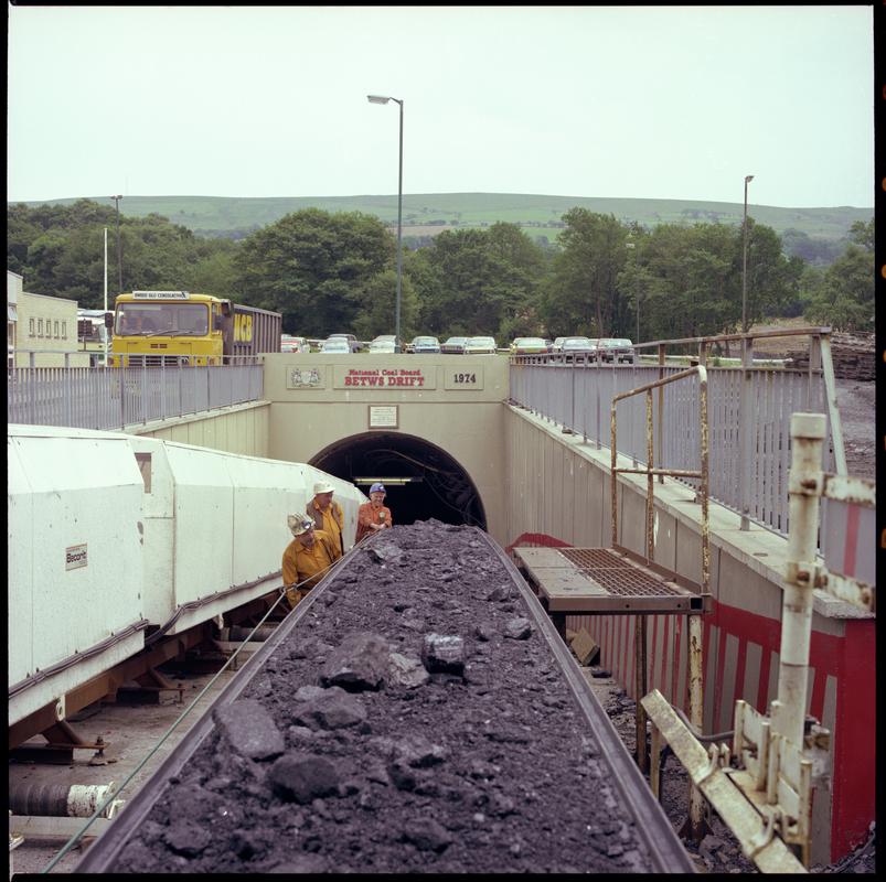 Colour film negative showing the entrance to the mine with man riding cars and conveyor, Betws Mine 10 June 1982.  '10 Jun 1982' is transcribed from original negative bag.