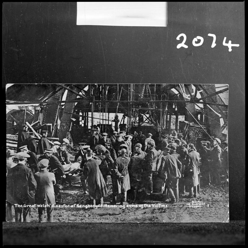 Black and white film negative of a photograph showing the scene at Universal Colliery, Senghenydd after the explosion of 14 October 1913.  Caption on photograph reads 'the Great Welsh disaster at Senghenydd.  Removing some of the victims'.