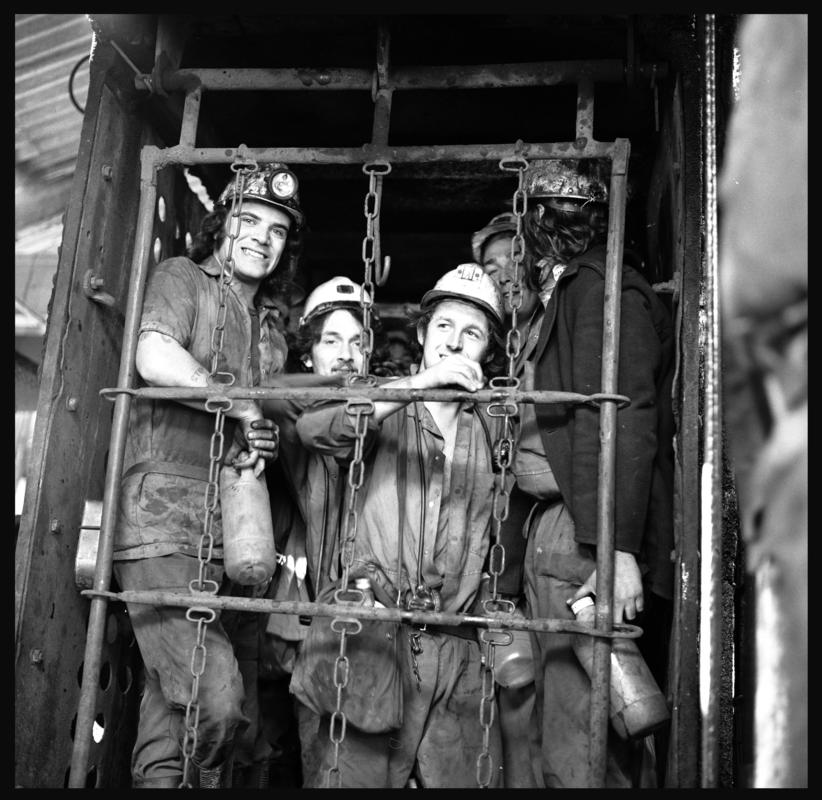Black and white film negative showing miners in the cage at pit top, Merthyr Vale Colliery, 21 September 1981.