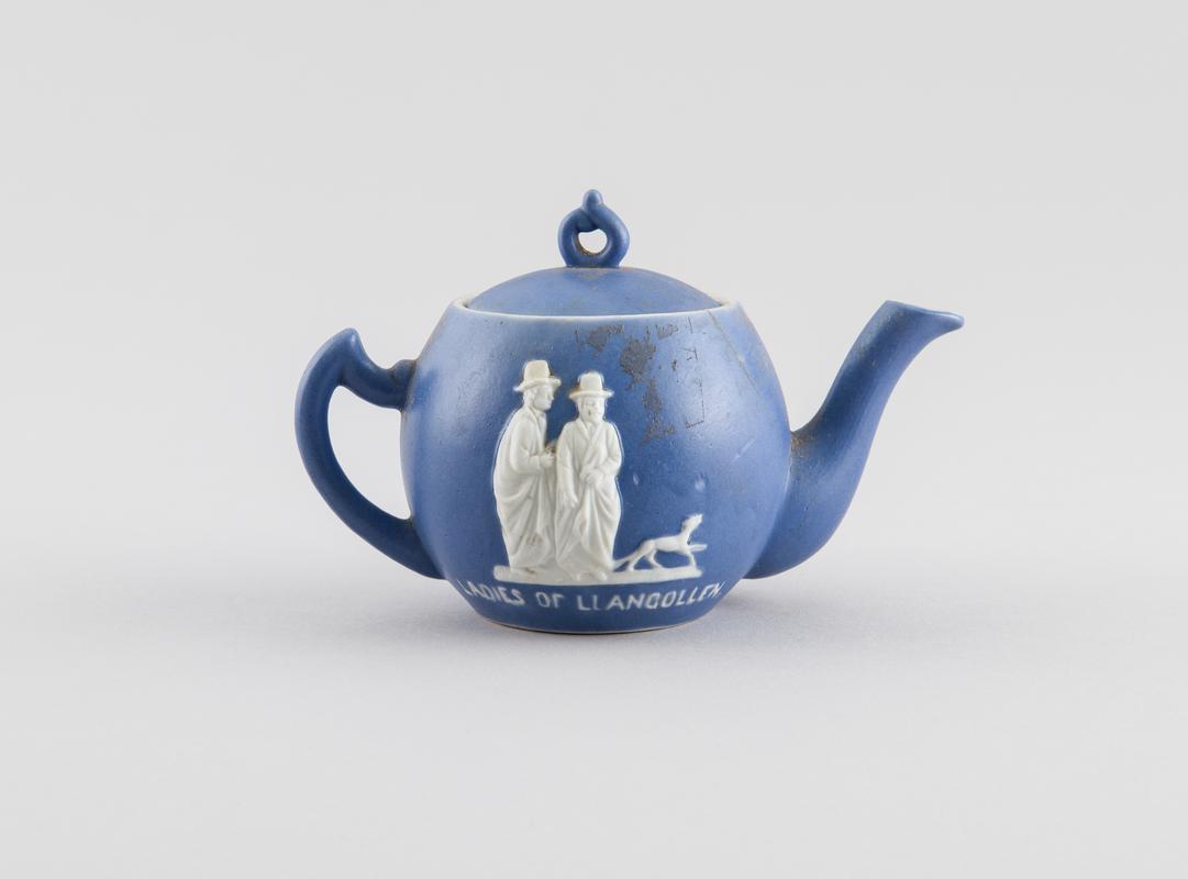 Teapot with white figures in relief on background of two sets of ladies one being Sarah Ponsonby and Lady Eleanor Butler - the Ladies of Llangollen.