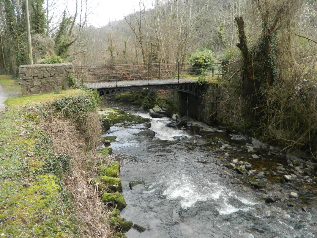 Cast iron bridge dated 1824 over river Clydach into Clydach Ironworks, viewed from west.