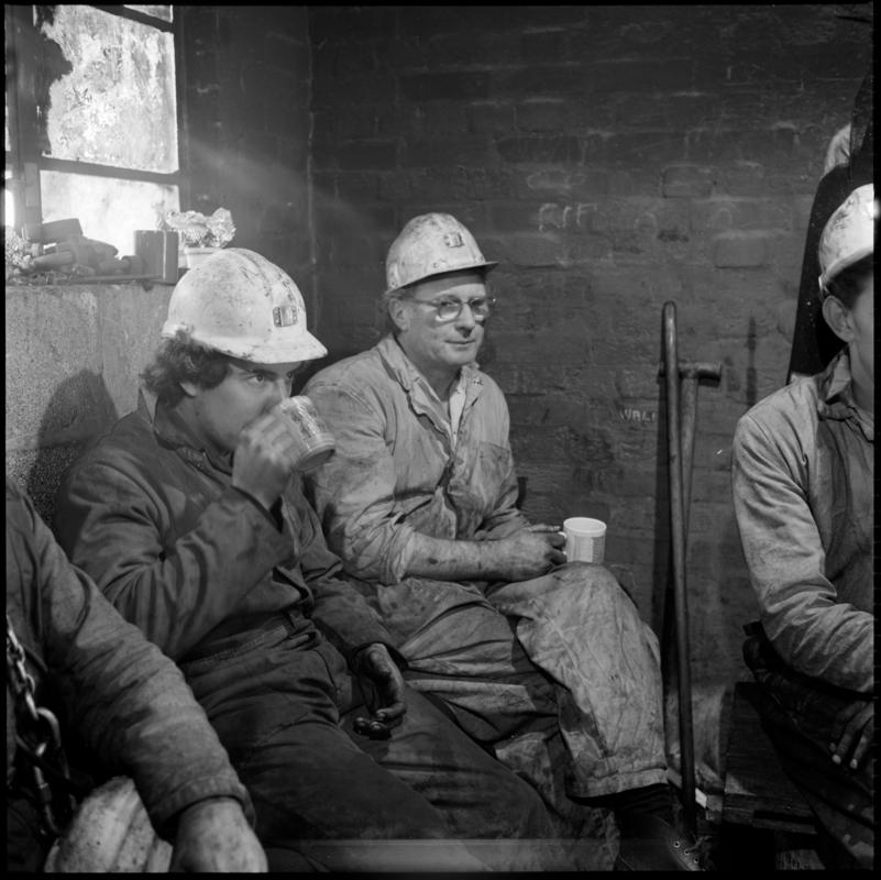 Black and white film negative of a photograph showing Celynen South Colliery workers on break, 6 November 1985.  'South Celynen 6 Nov 1985' is transcribed from original negative bag.