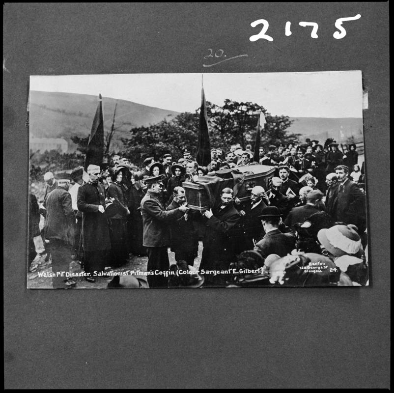 Black and white film negative of a photograph showing a coffin surrounded by a crowd, 1913.  Caption on photograph reads 'Welsh pit disasters.  Salvationist Pitman's Coffin (Colour Sargeant E. Gilbert)'.  'Sen 1913' is transcribed from original negative bag.