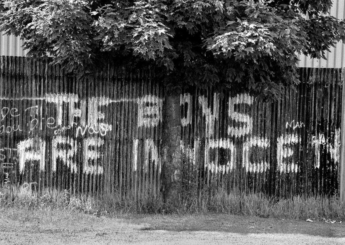 GB. WALES. Cardiff. Butetown - once know as 'Tiger Bay'. Graffiti supporting the Cardiff Three, wrongfully convicted of the murder of Lynette White. 2003