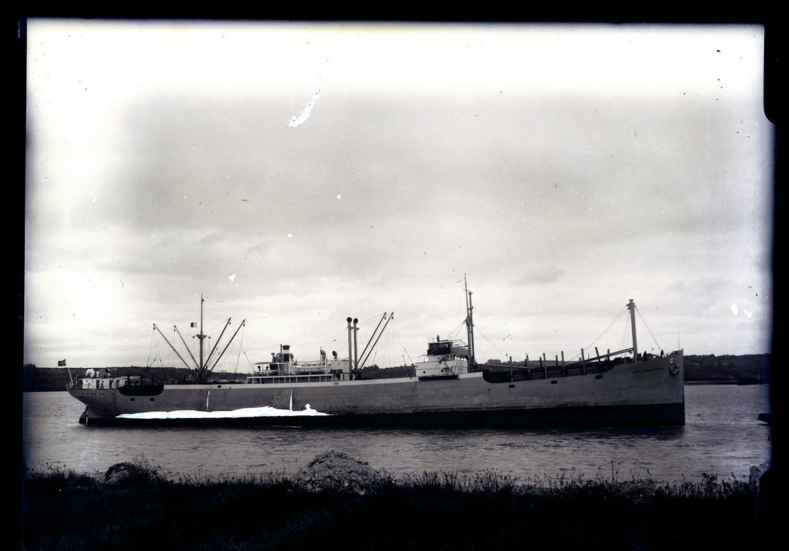 Starboard broadside view of M.V. CHR. KNUDSEN with timber deck cargo, c.1936.