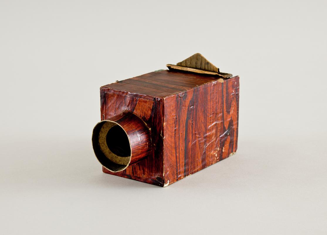 Home made camera using cigar box and covered in wood effect paper.