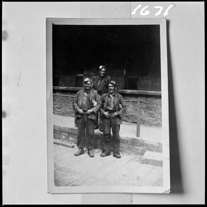 Black and white film negative of a photograph showing three workmen at Deep Navigation Colliery.