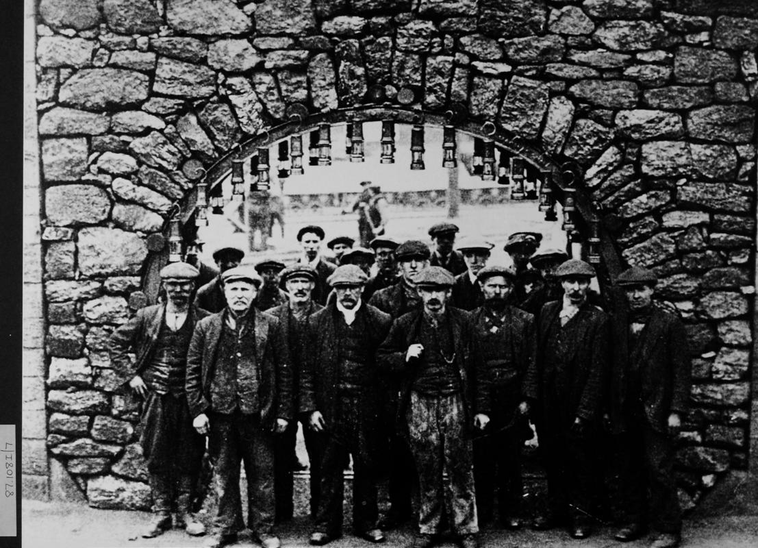 group of miners standing in front of coal arch