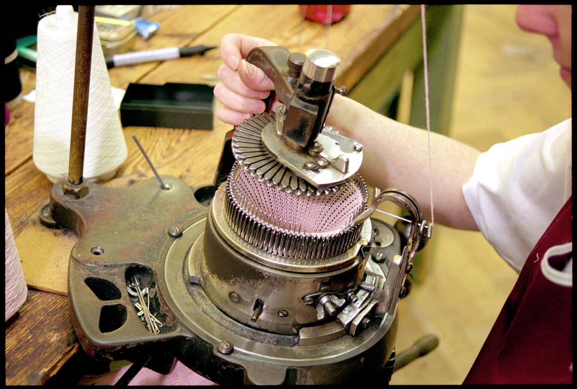 Andrea Rockman preparing to machine knit a pair of cashmere cable socks. Corgi Hosiery Ltd factory, Ammanford, 1 July 2002.