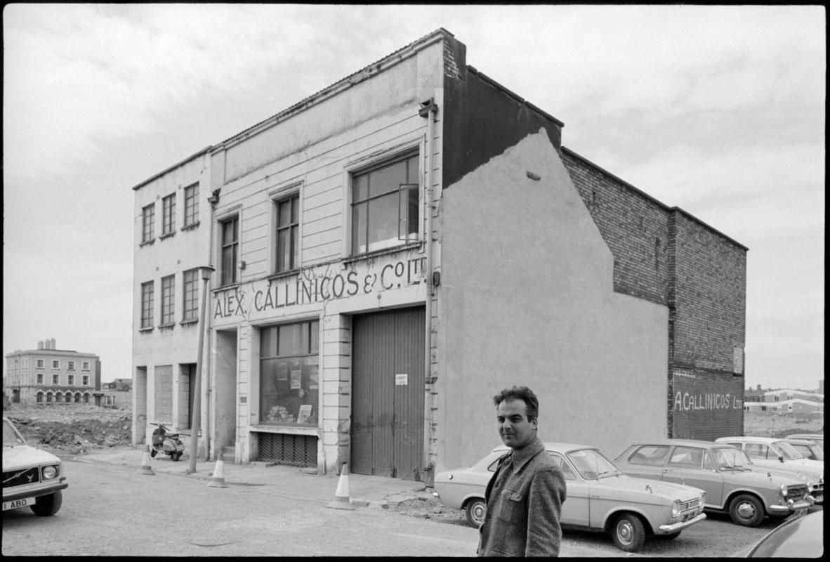 Exterior view of Alex Callincos & Co. Ltd., 45-47 George Street, Butetown. A partner in the Greek owned ship store, Mr V. Antippas is seen standing outside.
