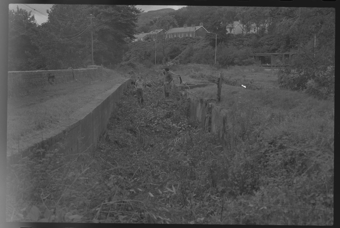 Possibly route of old canal with cottages in the background. Location unknown. (Canal Society)