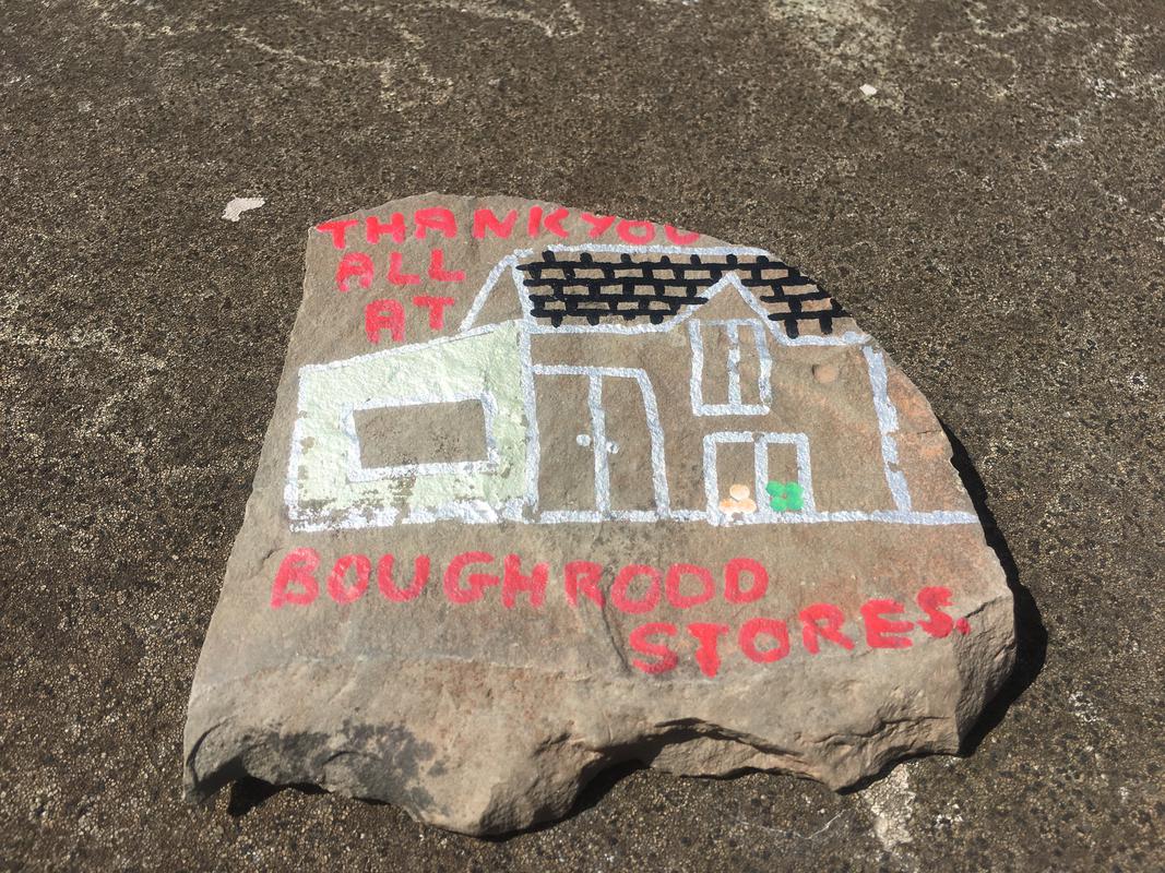 A pebble depicting a painting of Boughrood Stores reading 'Thank you all at Boughrood Stores' on Boughrood Bridge, over the River Wye, Boughrood, Powys.
