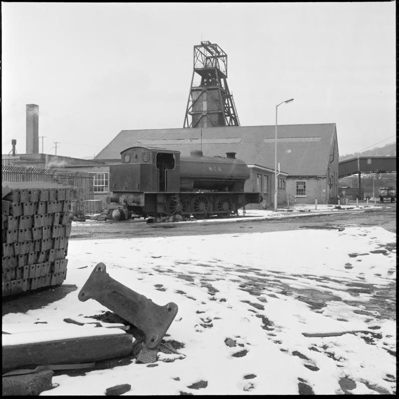 Black and white film negative showing a NCB steam locomotive in the Lady Windsor Colliery yard with the upcast shaft in the background.  'Lady Windsor' is transcribed from original negative bag.