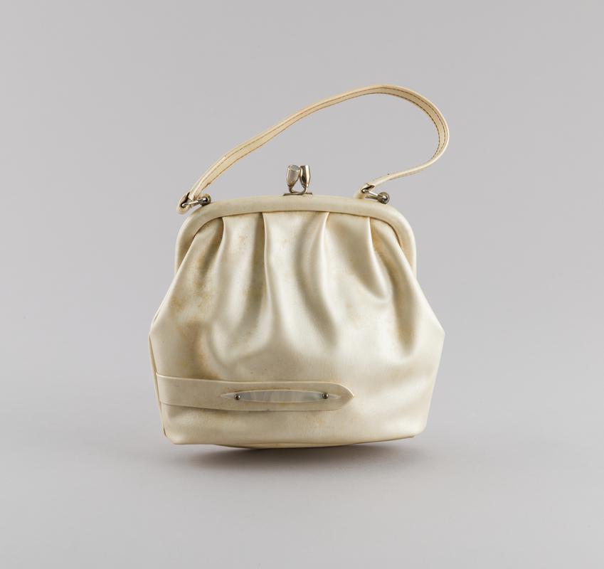 Ivory coloured clasped handbag used by Ivy Walker who emigrated from Jamaica in the 1960s.