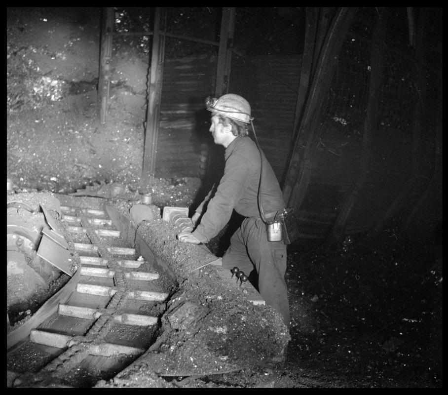 Black and white film negative showing a joy loader and operator, Cwmgwili Colliery, 1978.