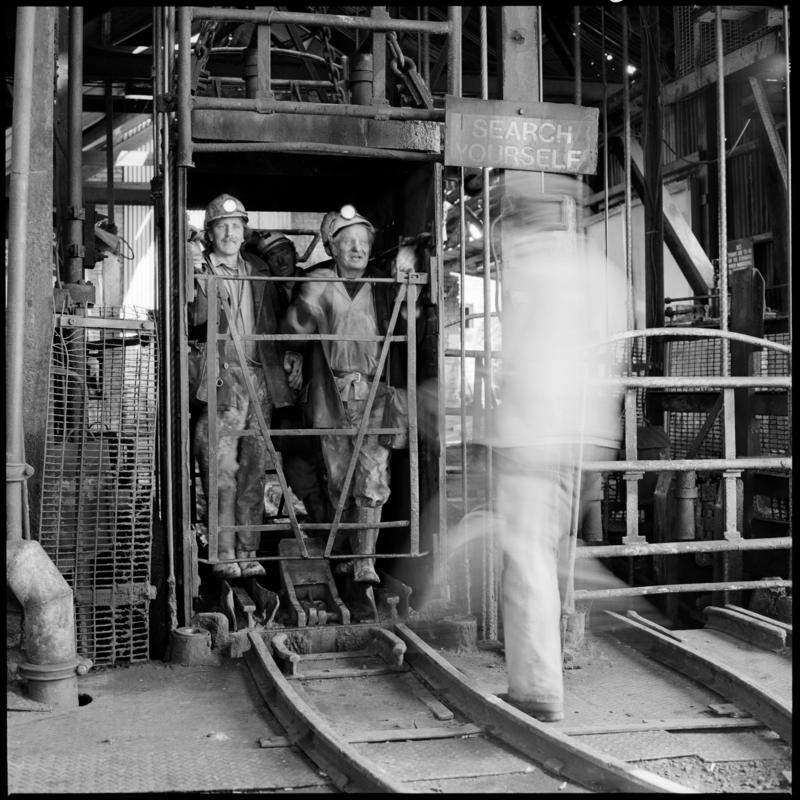 Black and white film negative showing miners in the cage, Morlais Colliery 13 May 1981.  'Morlais 13/5/81' is transcribed from original negative bag.
