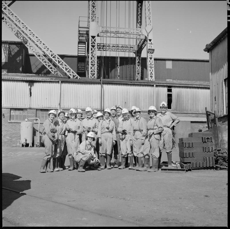 Black and white film negative showing a group of men on the surface, Lady Windsor Colliery.