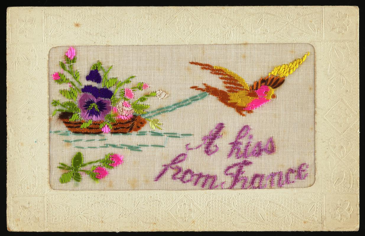 Embroidered postcard inscribed 'A kiss from France'. Handwritten message on back. Dated 18 September 1917. Sent to Miss Evelyn Hussey, sister of Corporal Hector Hussey of the Royal Welch Fusiliers, during the First World War.