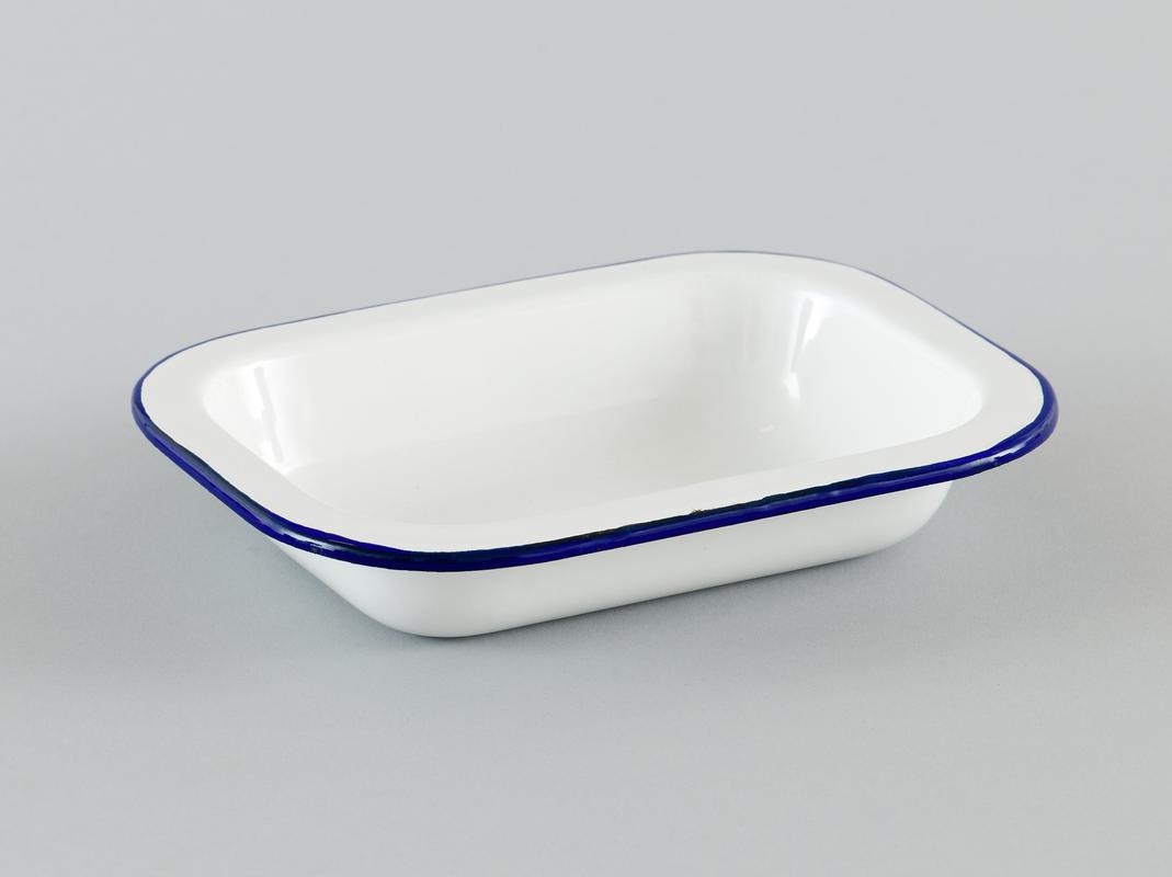 White enamelware rectangular casserole dish, with dark blue rim.