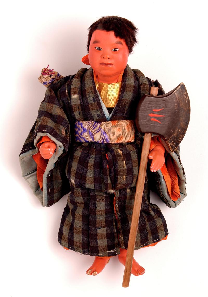 'Yamata' ningyo Japanese doll dressed as a samurai or warrior.  'Cotton wool torso encased in paper; head and upper torso, forearms and lower legs composed of a composition including kiri-wood sawdust and wheat starch; coated over with gofum and painted