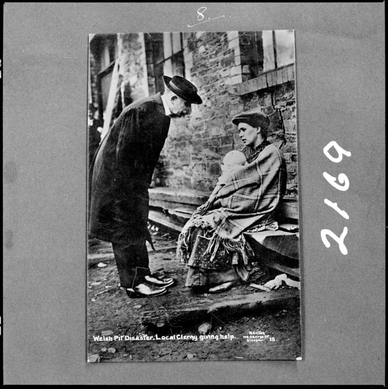 Black and white film negative of a photograph showing a local clergyman giving help, following the Universal Colliery disaster of 14 October 1913.  'Sen 1913' is transcribed from original negative bag.