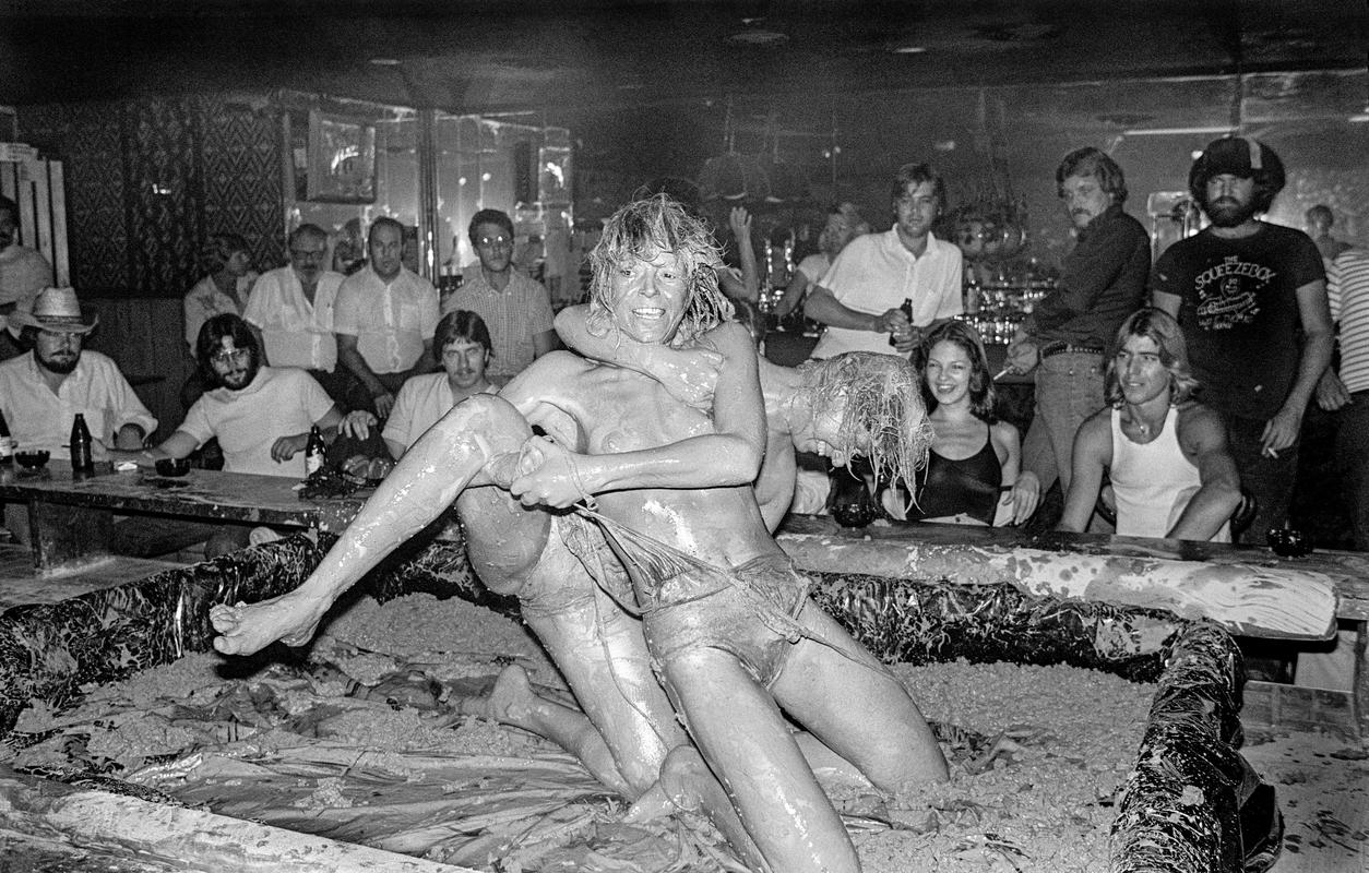 USA. ARIZONA. The Sand Box lounge in Phoenix.  Mudwrestling.  In theory no nudity allowed.  Nipples must have tape over them but the type and size of the tape is not stipulated. 1980.