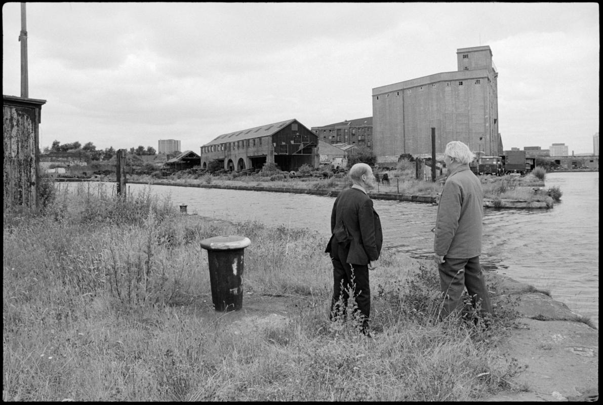 View of Hill's Dry Dock, Bute East Dock, with Mr R Coakley and Mr Jim Sullivan in the foreground, both of whom used to work there. Mr Coakley worked at the docks for 50 years, of which 20 years were at Junction Dry Dock and seven years at Hill's.