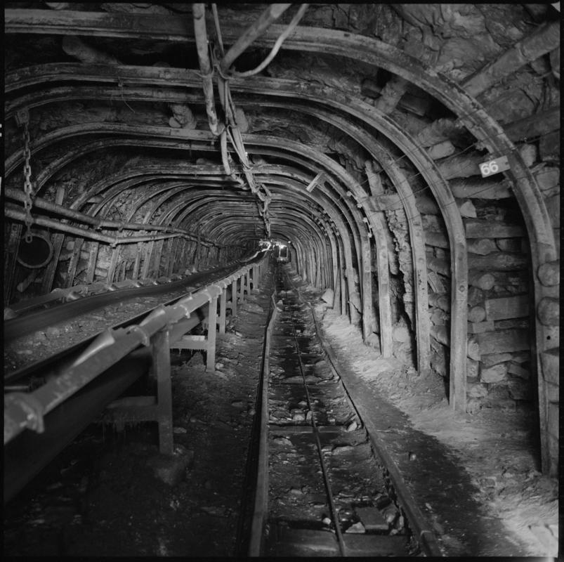 Black and white film negative showing a roadway with conveyor taking coal from the Garw seam to the new drift, Big Pit Colliery 1978.  'Blaenavon 1978' is transcribed from original negative bag.