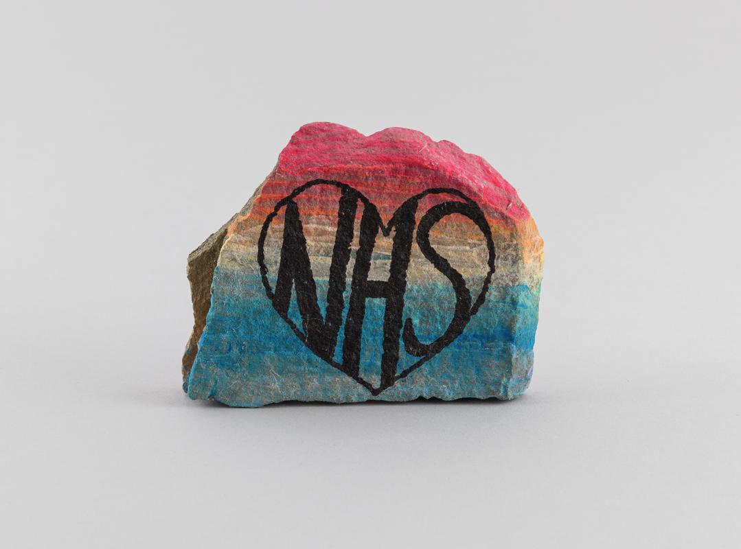 Stone painted with inscription 'NHS'