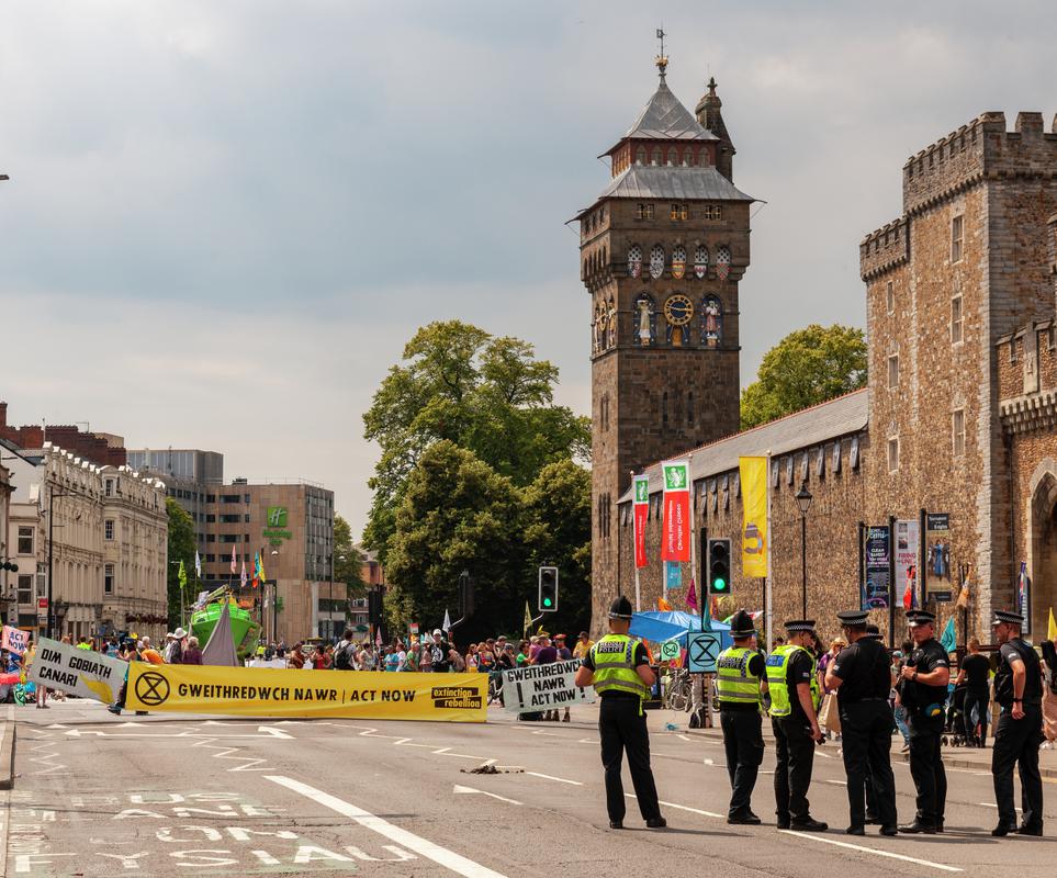 Extinction Rebellion Protest in Cardiff, blocking the road outside Cardiff Castle with a green yacht and Protest Slogans.